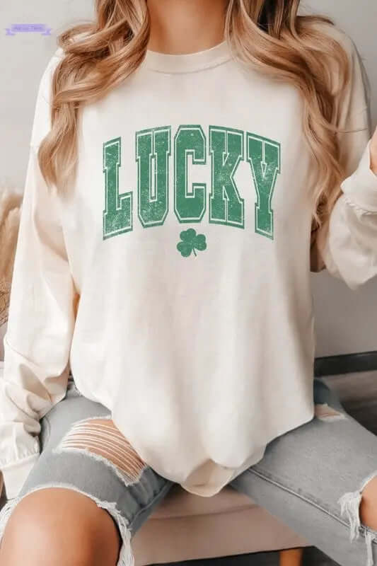 Lucky St Patrick's Day long sleeve shirt with green graphic and shamrock, perfect for festive celebrations. Aaria Tees
