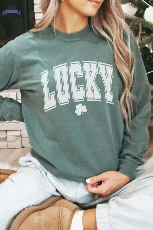 Woman wearing a green Lucky St Patrick's Day long sleeve shirt, styled casually for a festive look.