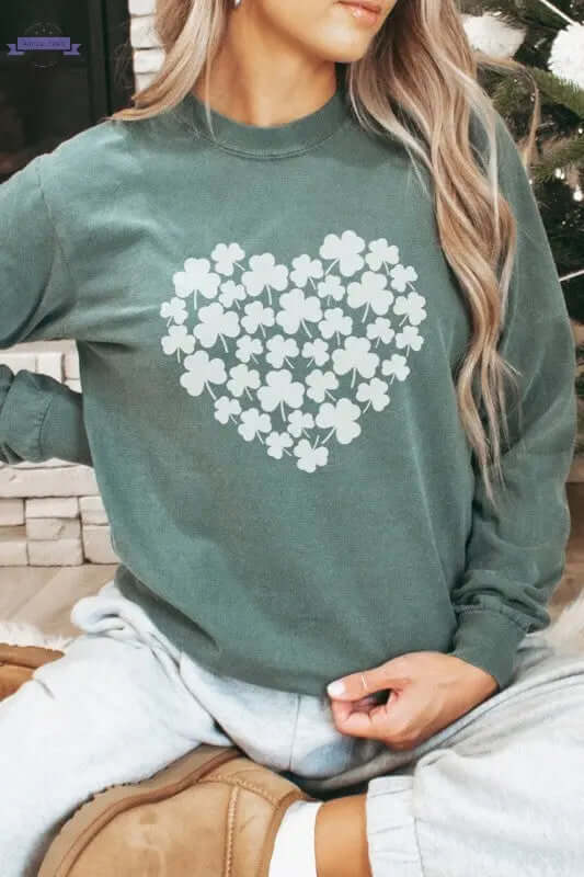 Model wearing Shamrock Heart St Patrick's Day Clover Long Sleeve shirt featuring a heart design made of clovers.